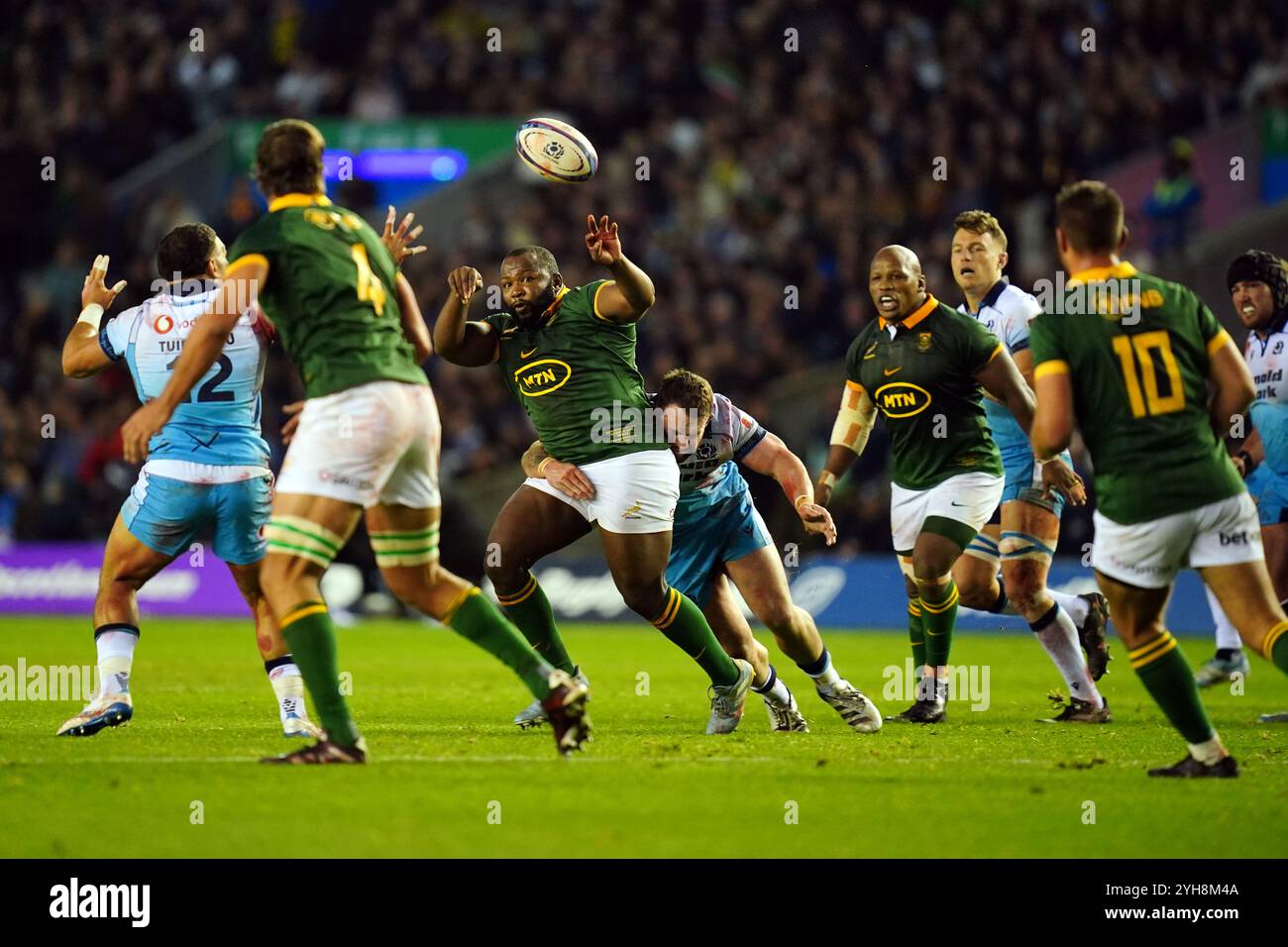 South Africa's Ox Nche (centre) passes the ball as they are tackled ...