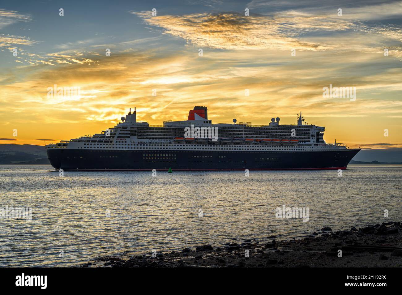 The Cunard ocean liner Queen Mary 2 on the River Clyde during a call at the Inverclyde port of Greenock. Stock Photo