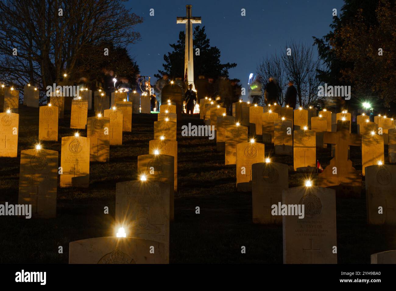 10th November 2024. Remembrance Sunday at Aldershot Military Cemetery in Hampshire, England, UK. The annual Lighting of the Graves ceremony took place in the evening. All the graves were adorned with a candle to remember the servicemen and women buried here who were killed in World War 1 and 2 and subsequent conflicts, and all those killed while in service, and a short Act of Remembrance was held in their honour. Stock Photo