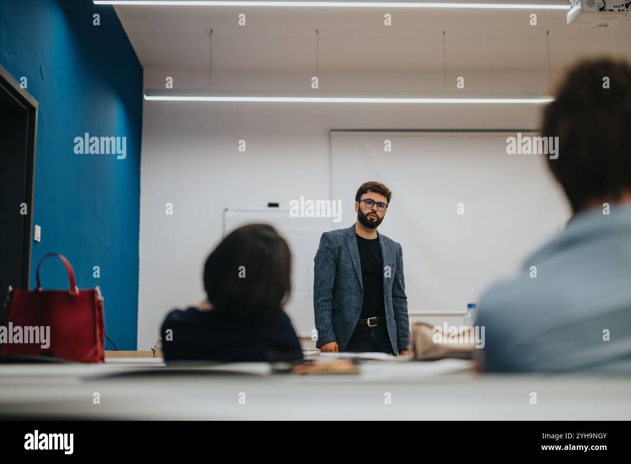 Professor assisting students during a classroom lesson Stock Photo