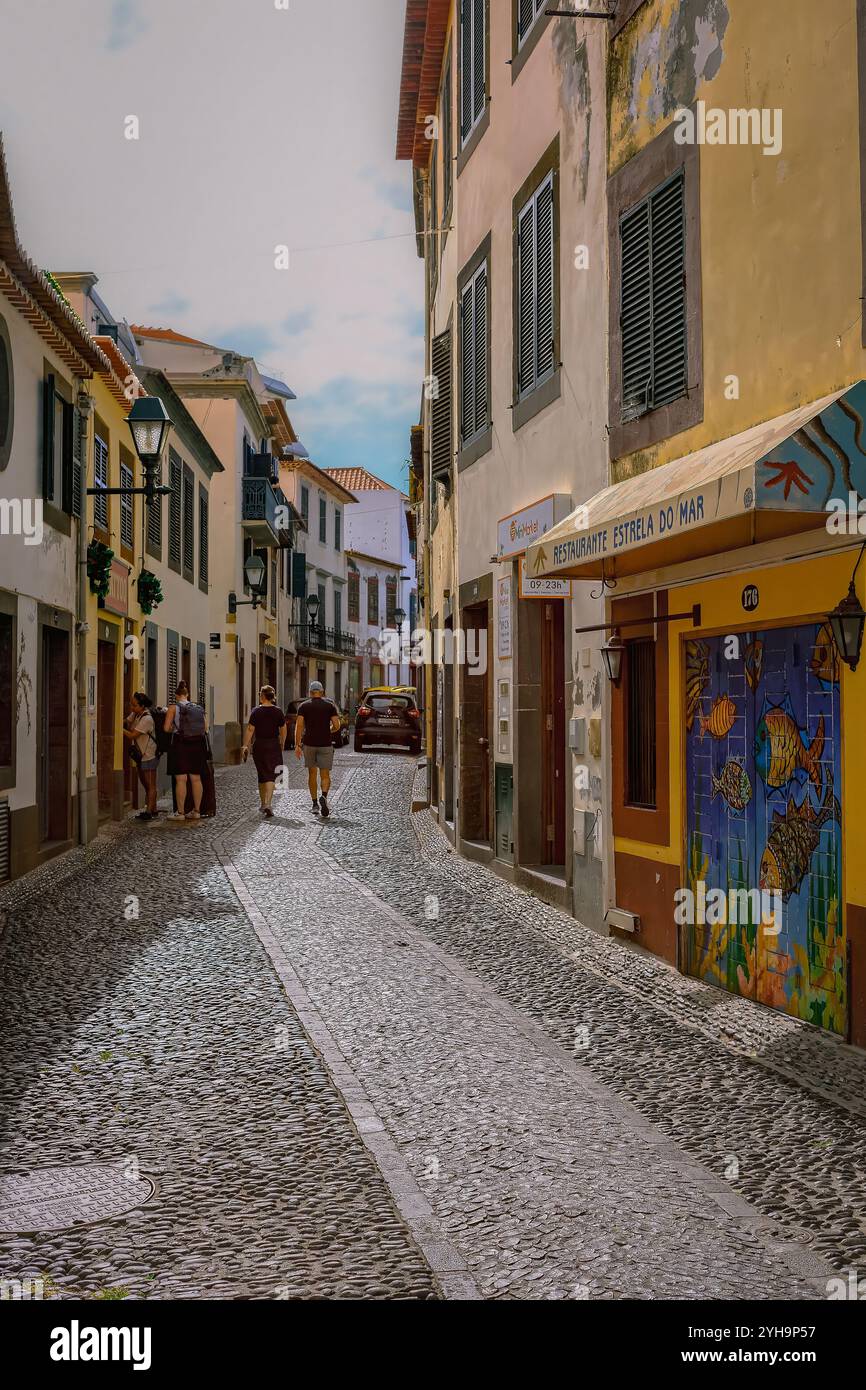 Charming cobblestone street with vibrant buildings and colorful tile ...