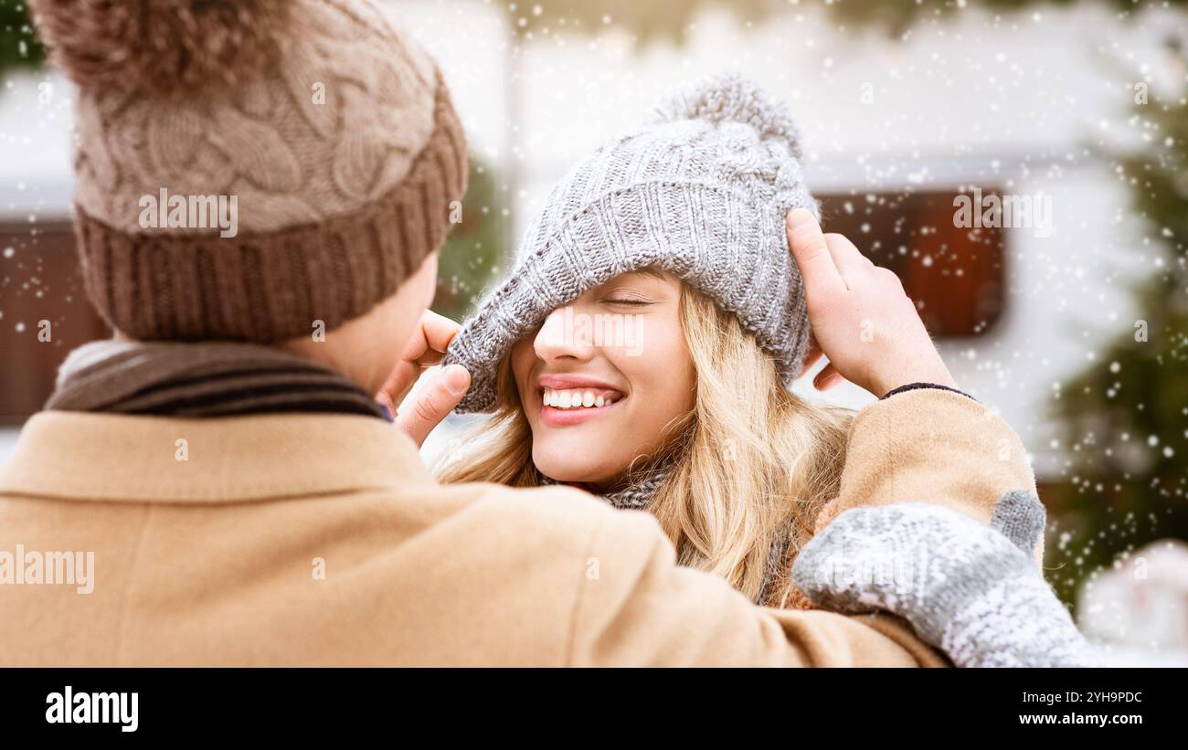 Couple playfully enjoying winter fun in a snowy park together Stock ...