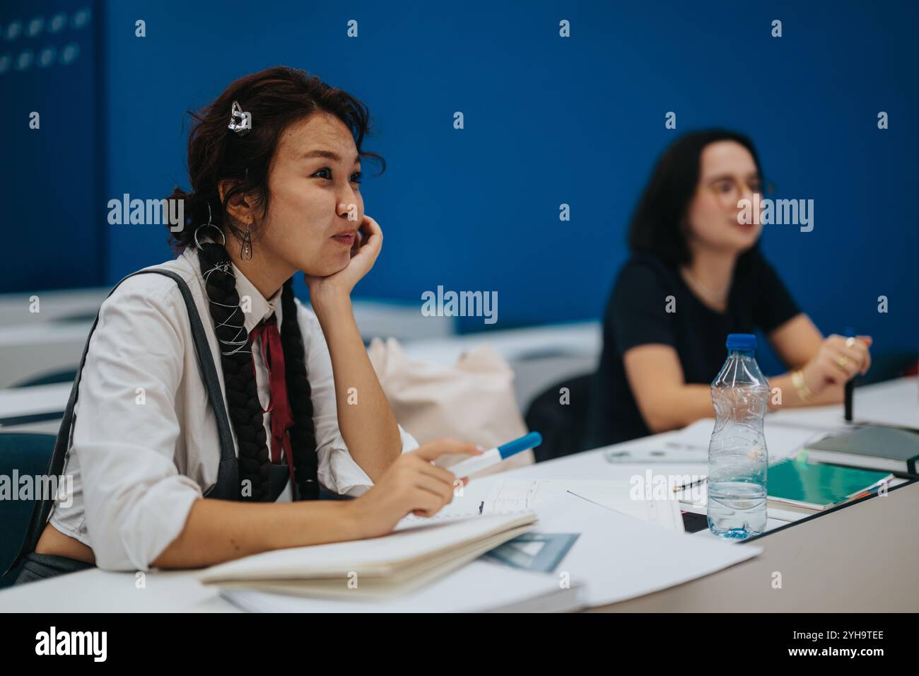 Attentive students listening during a classroom lecture session Stock Photo