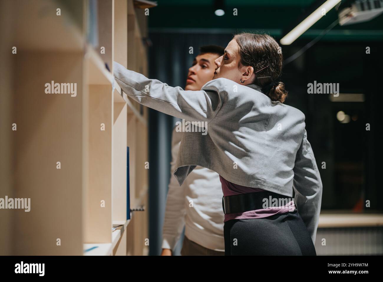High School Students Exploring Library Resources For Class Stock Photo