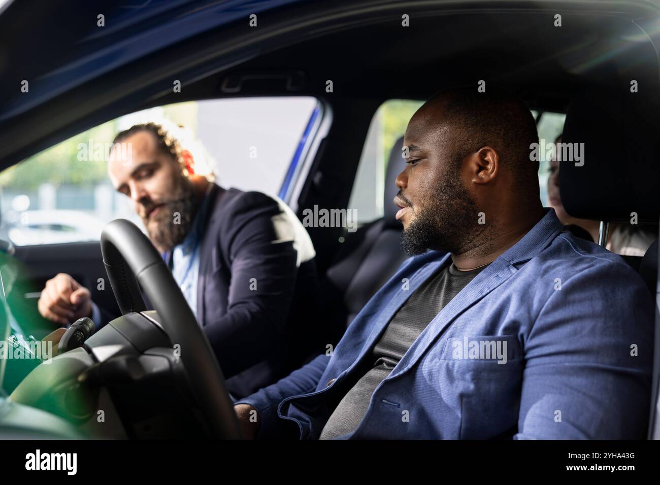 Car salesman explaining car features hi-res stock photography and ...