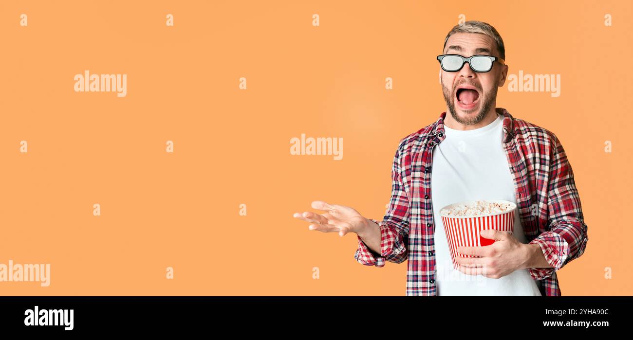 Scared guy in 3d glasses tossed popcorn Stock Photo