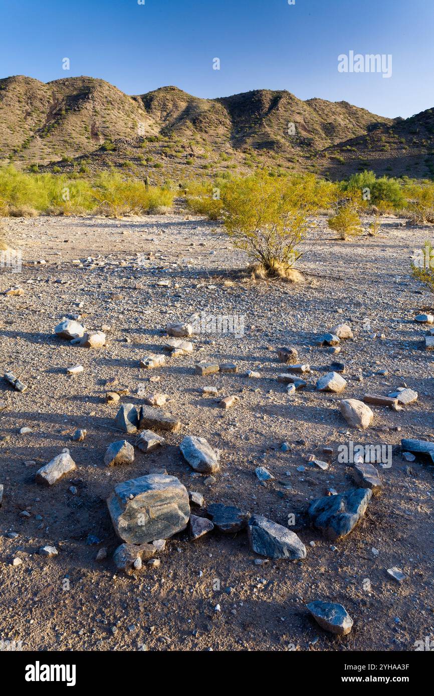 A cluster of loose rocks scattered across the desert floor below the ...