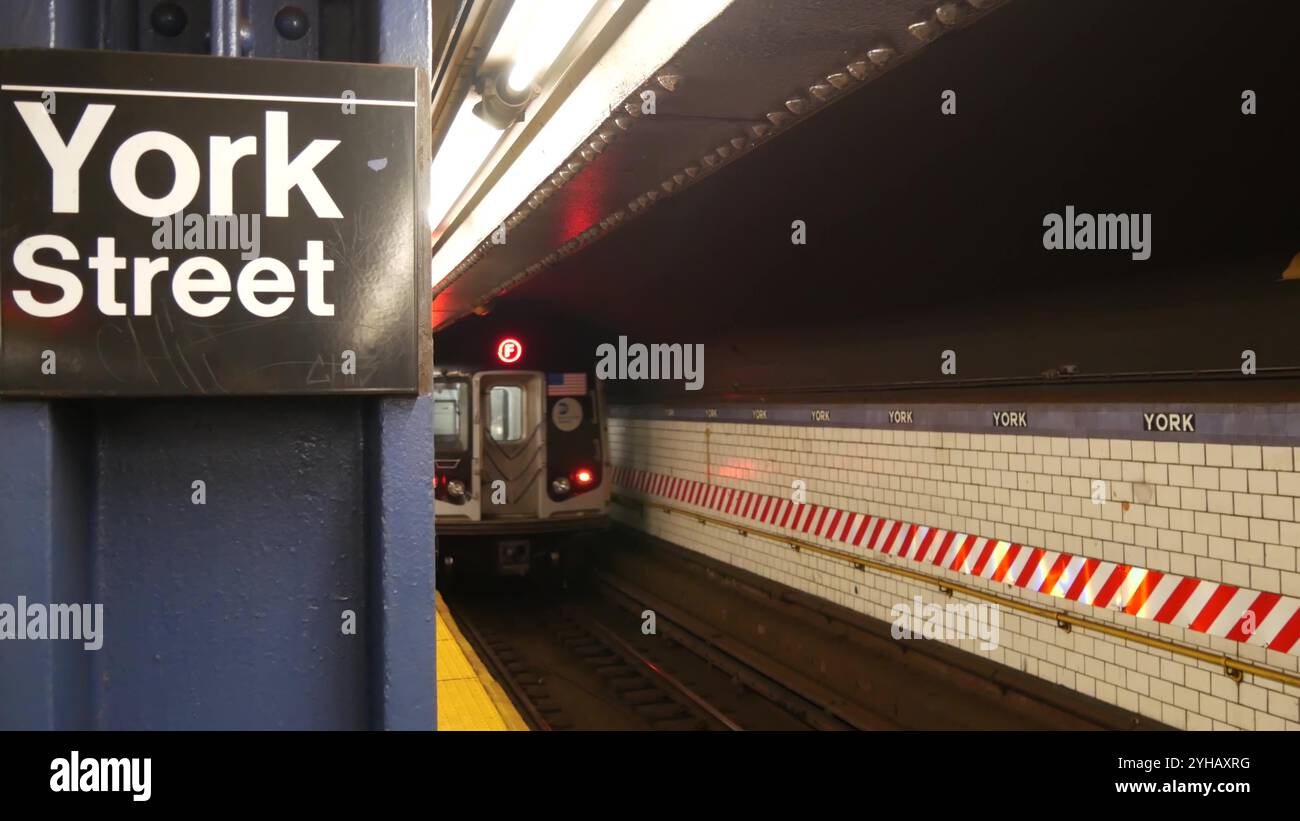 New York City subway station interior, underground metropolitan platform sign. Metro train, railway passenger public transport, United States. Text signboard: York Street. Brooklyn Downtown, NYC. Stock Photo