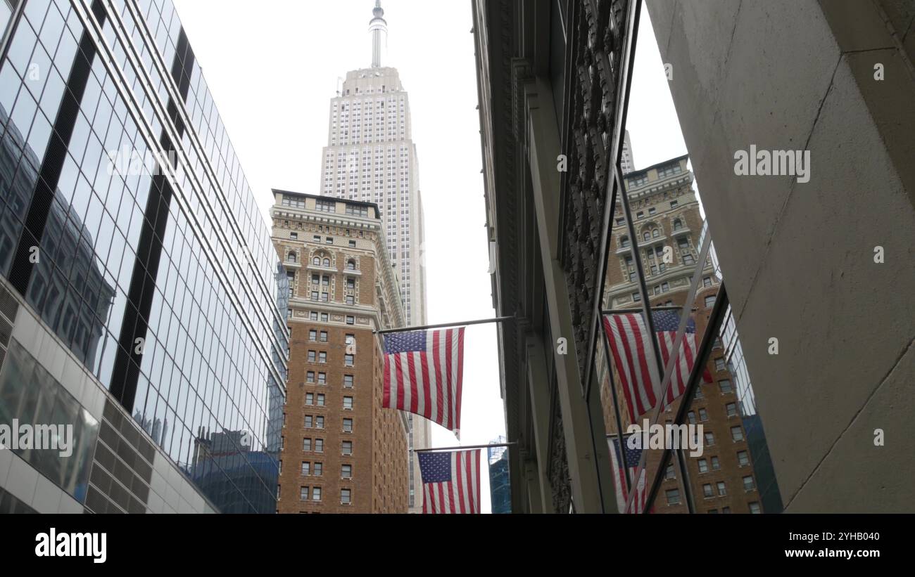 New York, american flag waving. Empire State Building. Manhattan ...