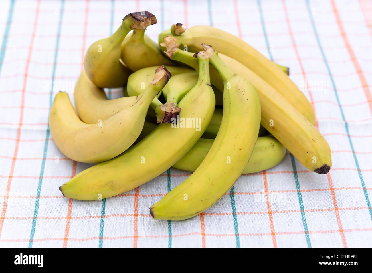 Ripe yellow bananas on white table cloth view from above Stock Photo