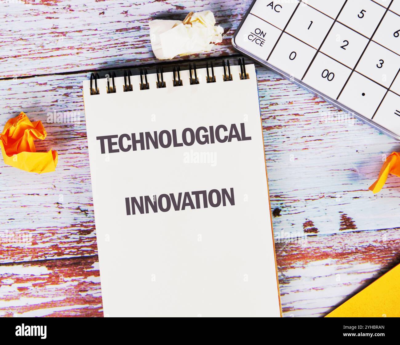 Business, programming, interface, application and network concept. Text TECHNOLOGICAL INNOVATION in a notebook against the background of old boards. Stock Photo