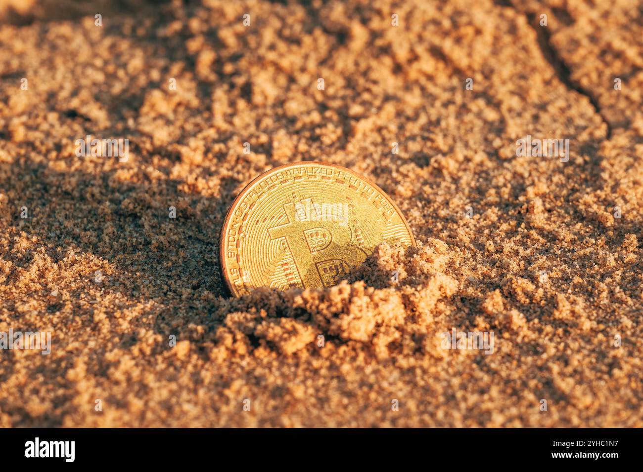 Coin bitcoin buried in the sand on the beach. Bitcoin is the most popular  cryptocurrency in the world Stock Photo - Alamy