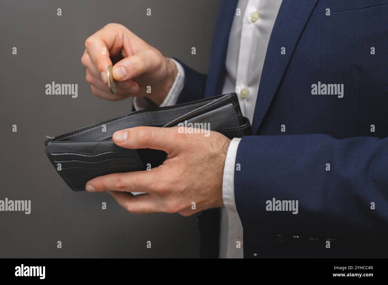 Putting Wallet Hand putting coin in purse hi-res stock photography and images - Alamy