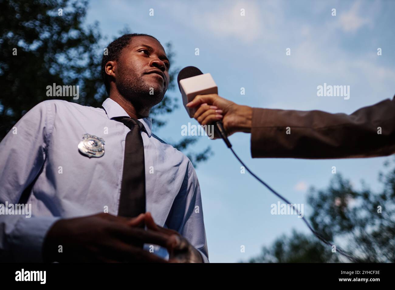 Policeman giving interview reporter outdoors hi-res stock photography ...
