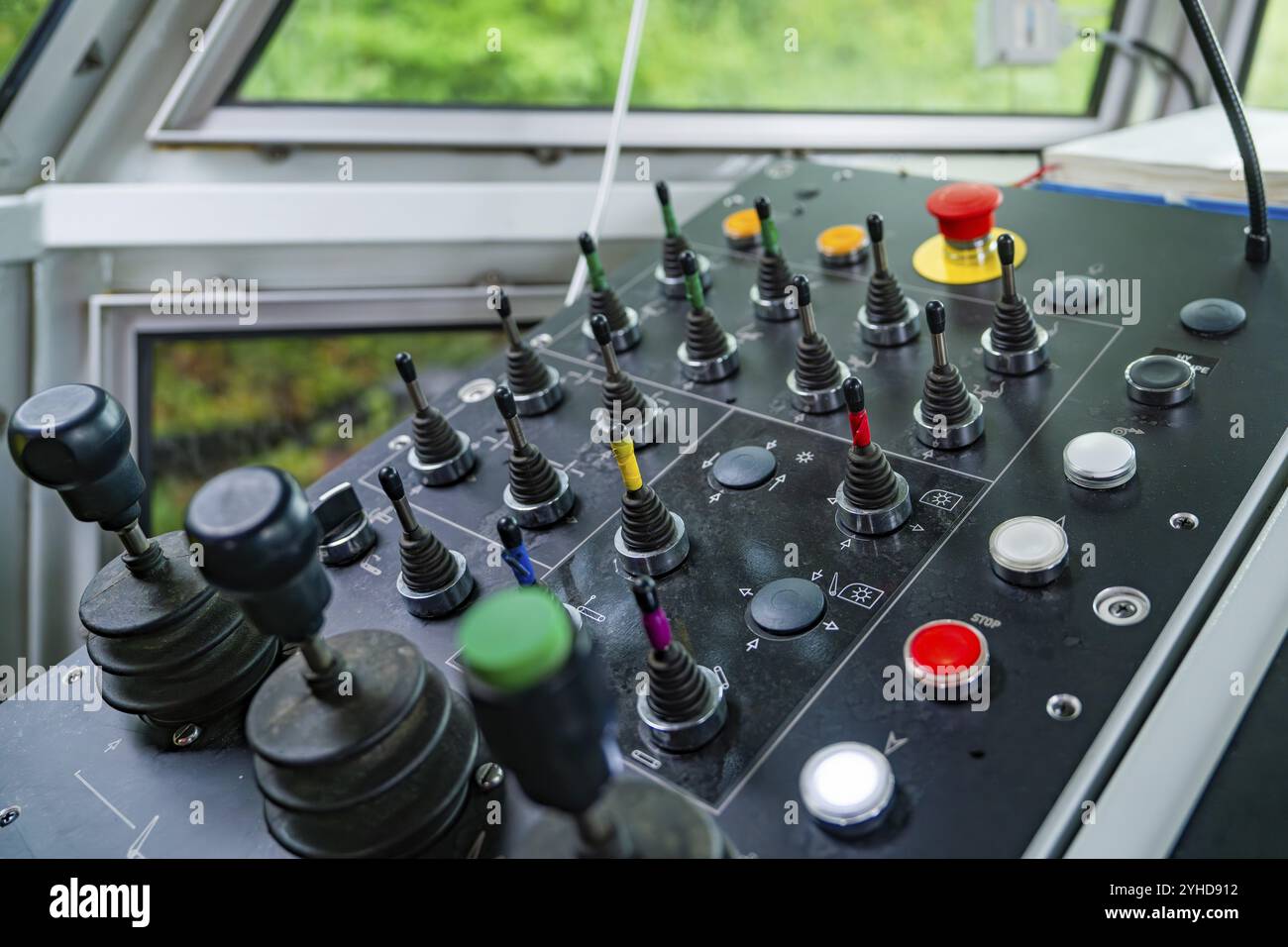 Detail of a control panel with numerous colour-coded levers and buttons ...