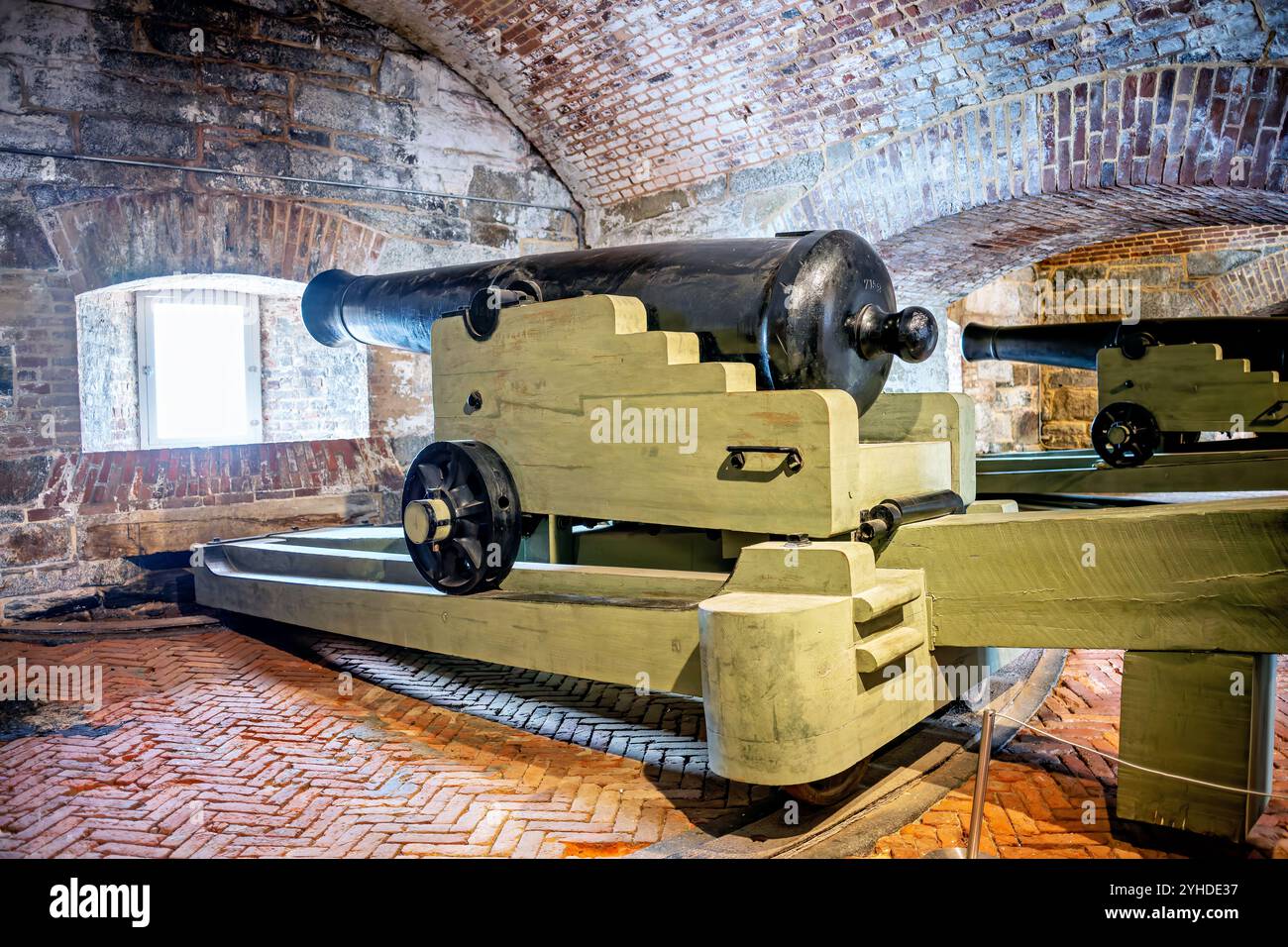 HAMPTON, Virginia — Artillery display at Fort Monroe's Casemate Museum demonstrates historic coastal defense weaponry. The exhibit showcases period cannon installations within the fort's original casemate architecture. This preserved fortification system illustrates military engineering and coastal defense strategies of the 19th century. Stock Photo