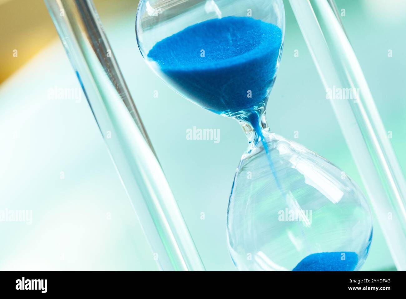 Time passing. Blue hourglass Stock Photo - Alamy