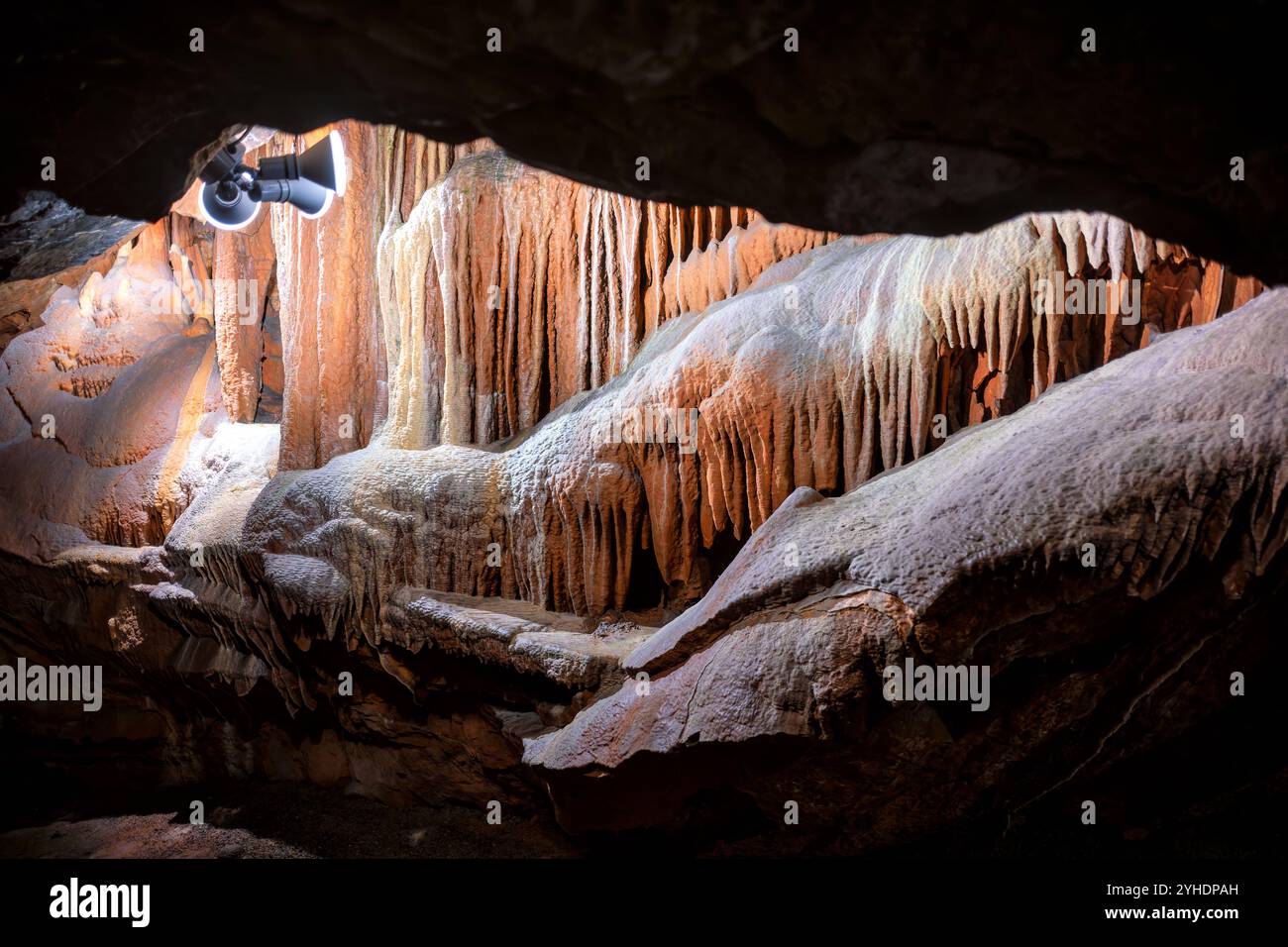 Shenandoah Caverns Cave Formations Quicksburg Virginia // QUICKSBURG, Virginia — Shenandoah Caverns, discovered in 1884 during railroad quarrying operations on Abraham Neff's property, features extensive limestone cave formations accessible by elevator. The caverns, developed for tourism in 1922 by Hunter Chapman, remain the only show cave in Virginia with elevator access. The cave system showcases natural formations including stalactites, stalagmites, and flowstone throughout its developed passageways. Stock Photo