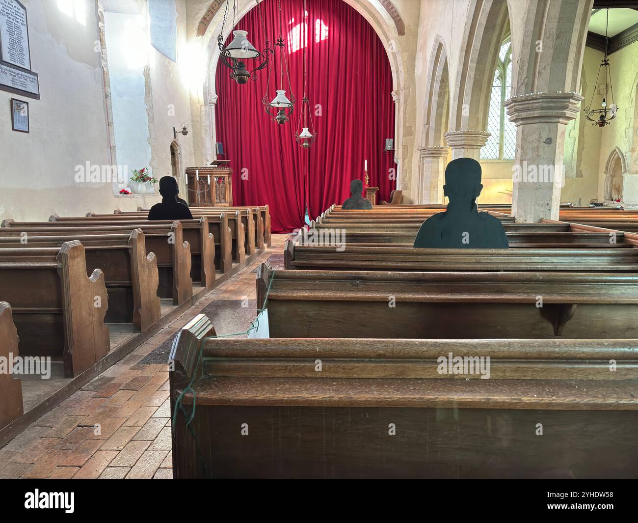 First World War remembrance figures of soldiers sitting  in church pews,  Framsden, Suffolk, England, UK - Smartphone Captured Stock Image