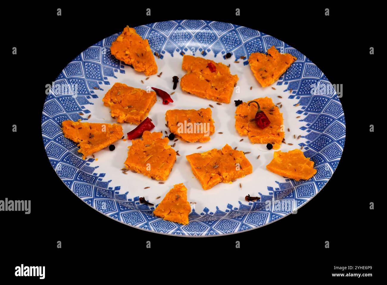 Gujarati Kathiyawadi Spicy Dhokali pieces Sabji highlights dish, isolated on black background Stock Photo