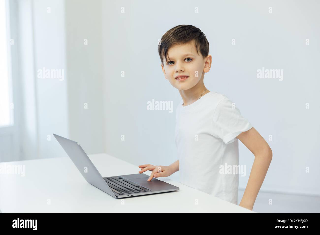 Schoolboy At Desk Playing In Laptop Stock Photo - Alamy