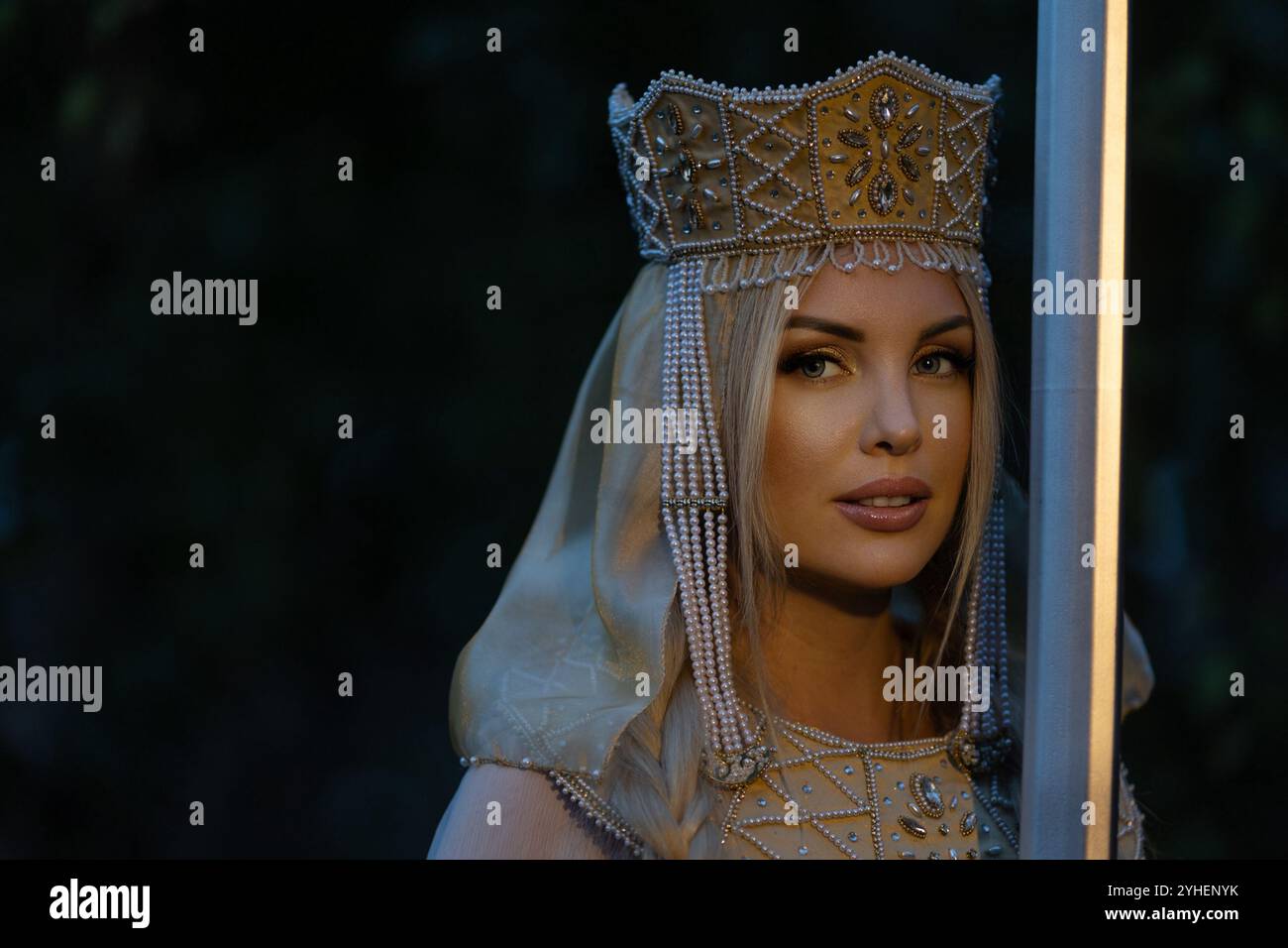 Portrait of a beautiful girl wearing a kokoshnik (crown) and ...