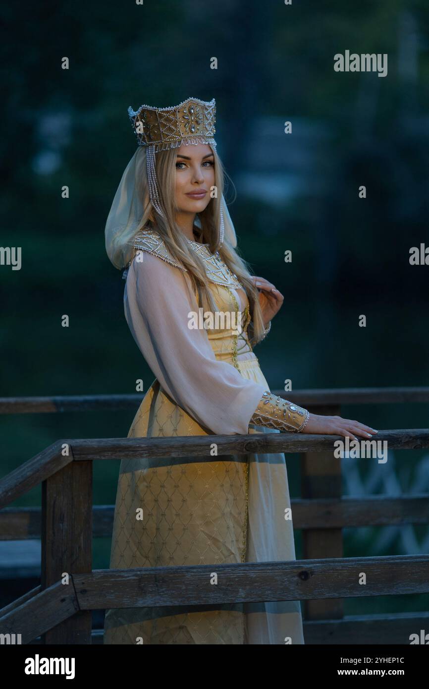 Portrait of a beautiful girl wearing a kokoshnik (crown) and ...