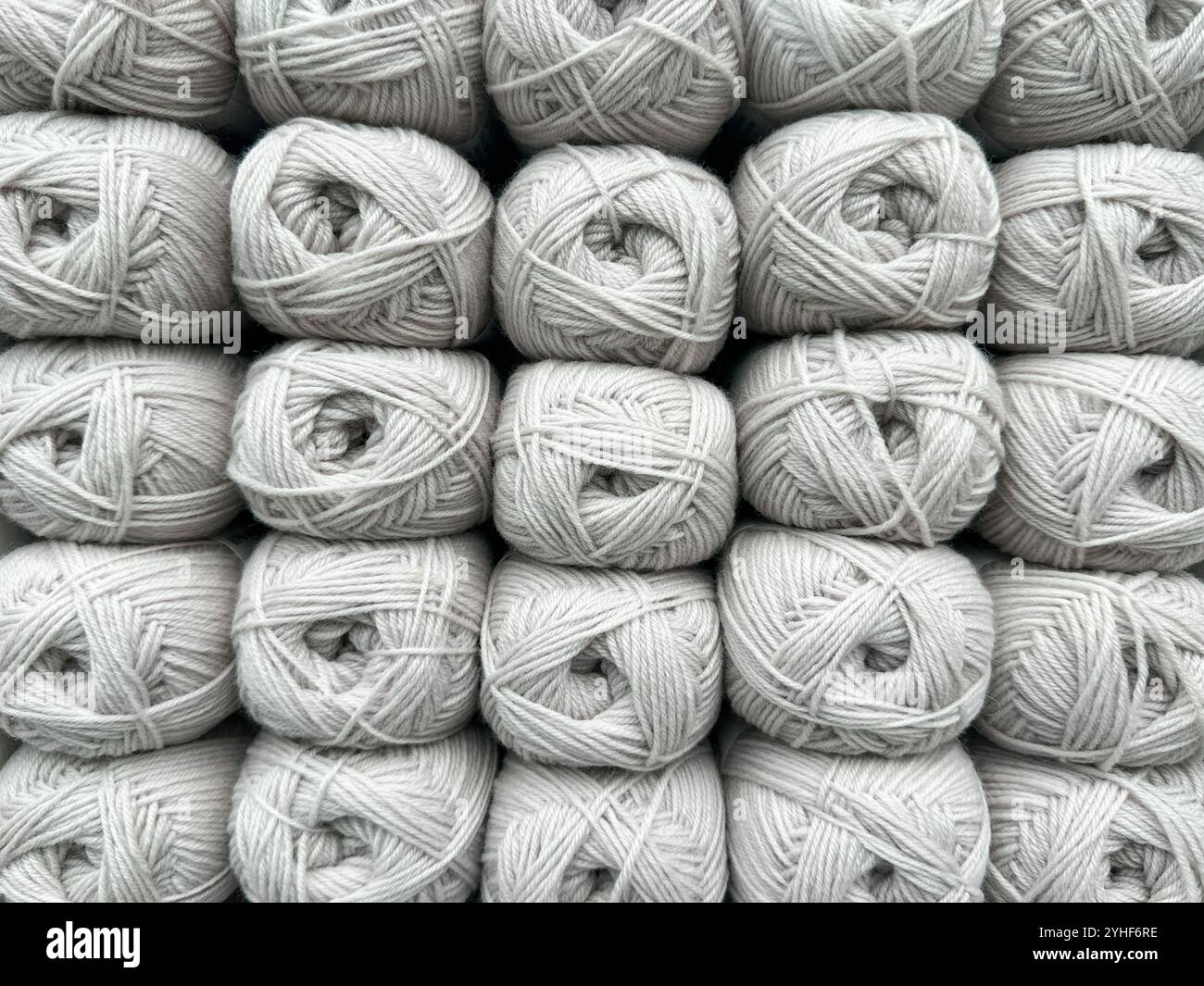 Close up view of balls of beige wool on display in a knitting shop - Smartphone Captured Stock Image
