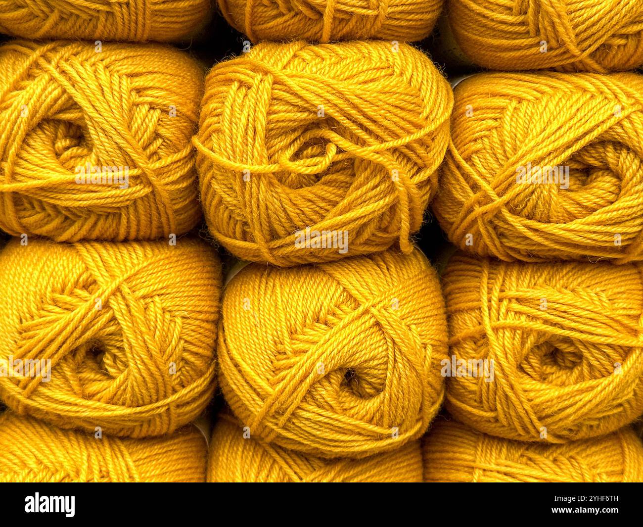 Close up view of balls of yellow wool on display in a knitting shop - Smartphone Captured Stock Image