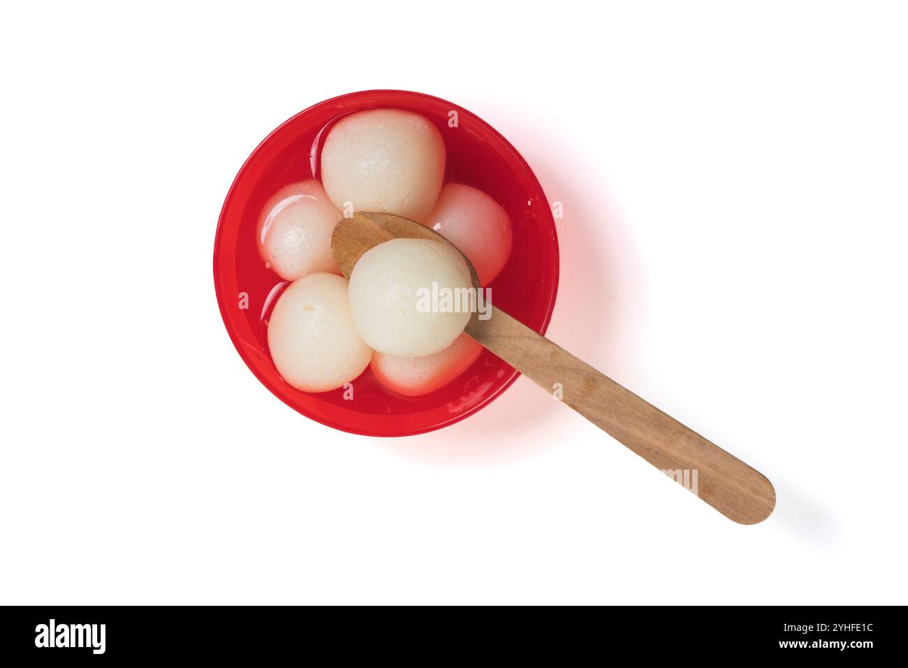 Traditional Indian sweet Rasgulla served in a red bowl with a wooden ...