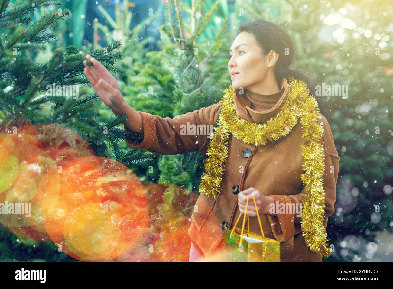 Woman choosing christmas tree hi-res stock photography and images - Alamy