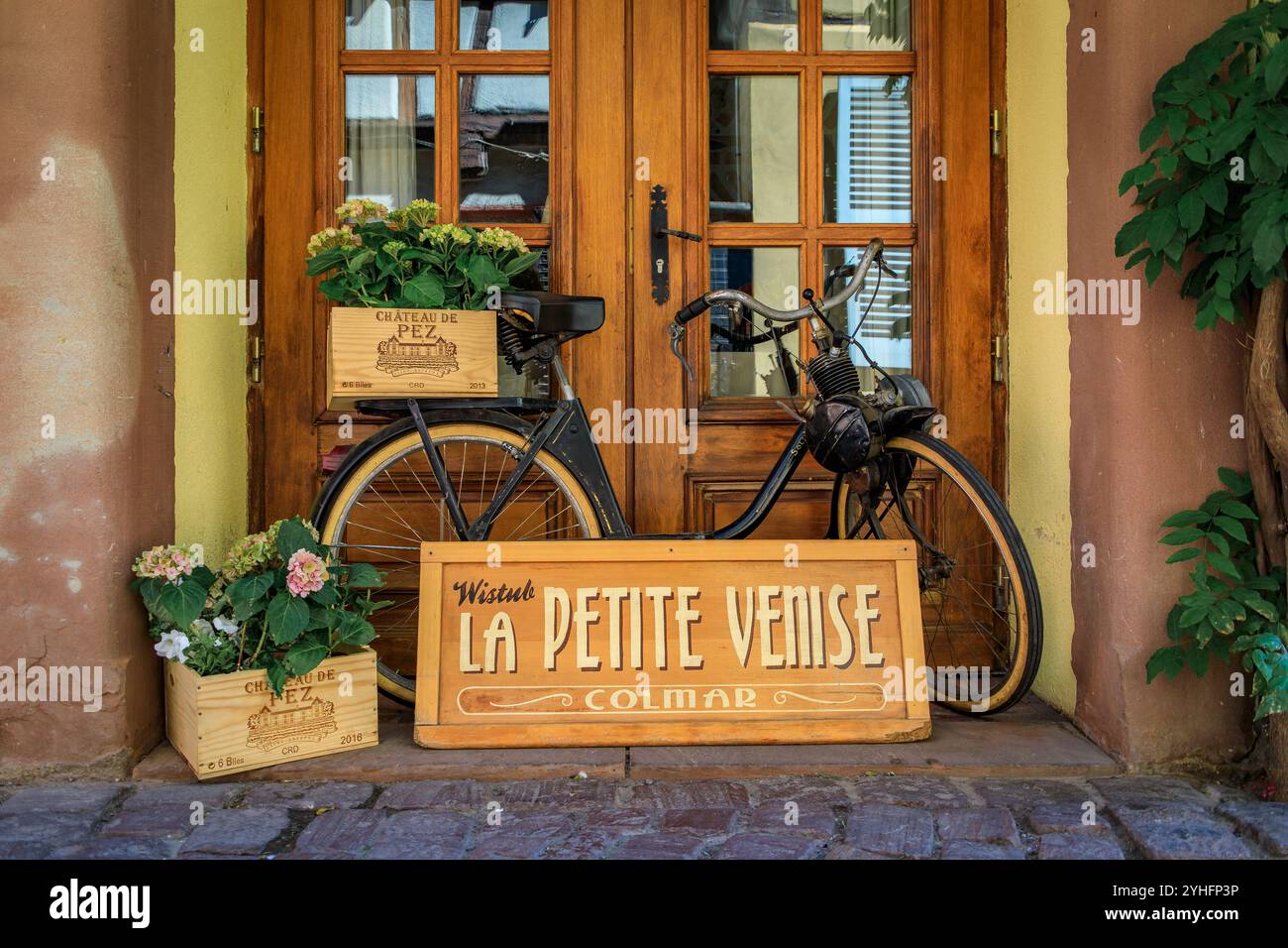 Colmar, France - June 5, 2023: Ornate facade of Alsatian winstub restaurant in a traditional half timbered house with flowers in Little Venice, Alsace Stock Photo