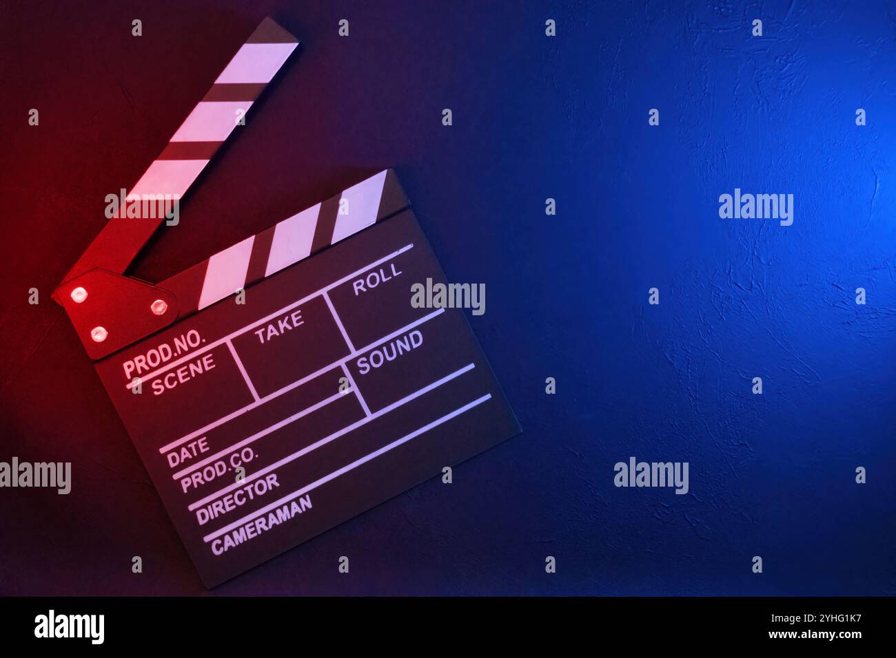 Clapperboard on black background with red and blue light, top view Stock Photo
