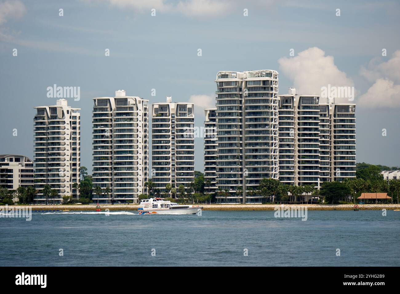 Cape Royal development luxury flats pictured from the Singapore Strait showing the waterfront and passing boats. Stock Photo