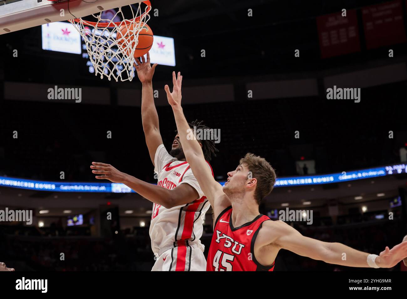 Columbus, Ohio, USA. 11th Nov, 2024. Ohio State Buckeyes forward Sean Stewart (13) lays up a shot over Youngstown State Penguins center Gabe Dynes (45) during the game between the Youngstown State Penguins and the Ohio State Buckeyes at Value City Arena, Columbus, Ohio. (Credit Image: © Scott Stuart/ZUMA Press Wire) EDITORIAL USAGE ONLY! Not for Commercial USAGE! Stock Photo