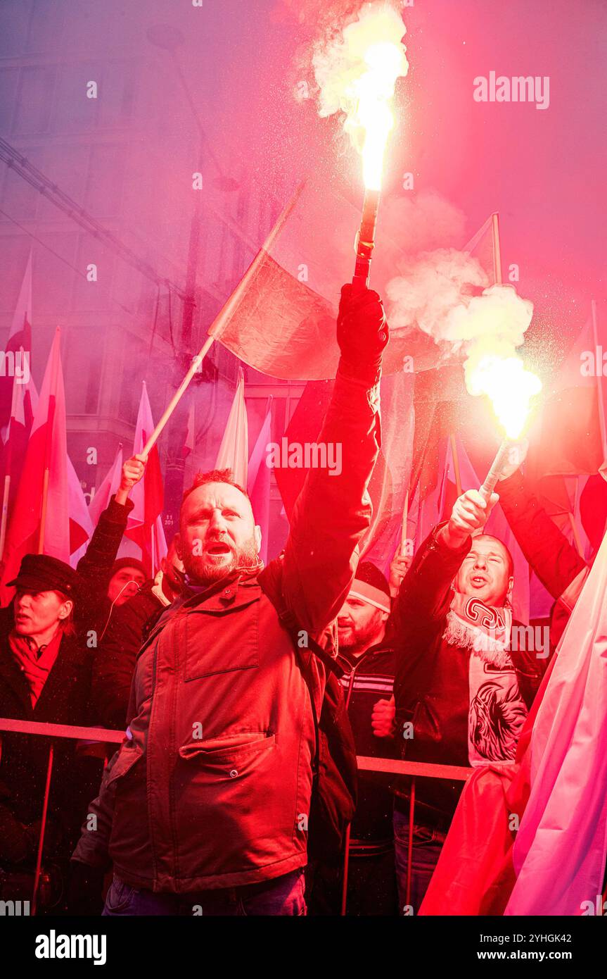 Warsaw, Poland. 11th Nov, 2024. Participants light and raise flares before the procession begins. Polish citizens from all over the country march through the streets of Warsaw to celebrate Independence Day. The event gathers tens of thousands of participants, with patriotic Poles gathering to celebrate. Many families bringing their children. Credit: SOPA Images Limited/Alamy Live News Stock Photo