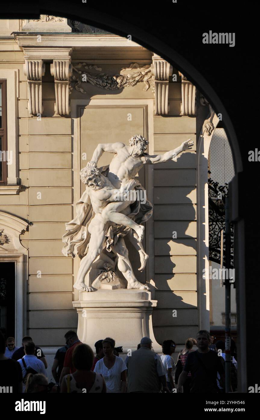 Sculpture of the mythological heroes Hercules and Antaeus in front of the wing of the Reich Chancellery in the courtyard of the Hofburg. Vienna Stock Photo