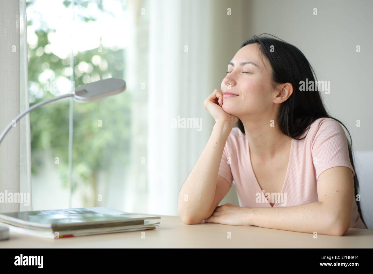 Relaxed asian woman resting in a room with eyes closed at home Stock ...