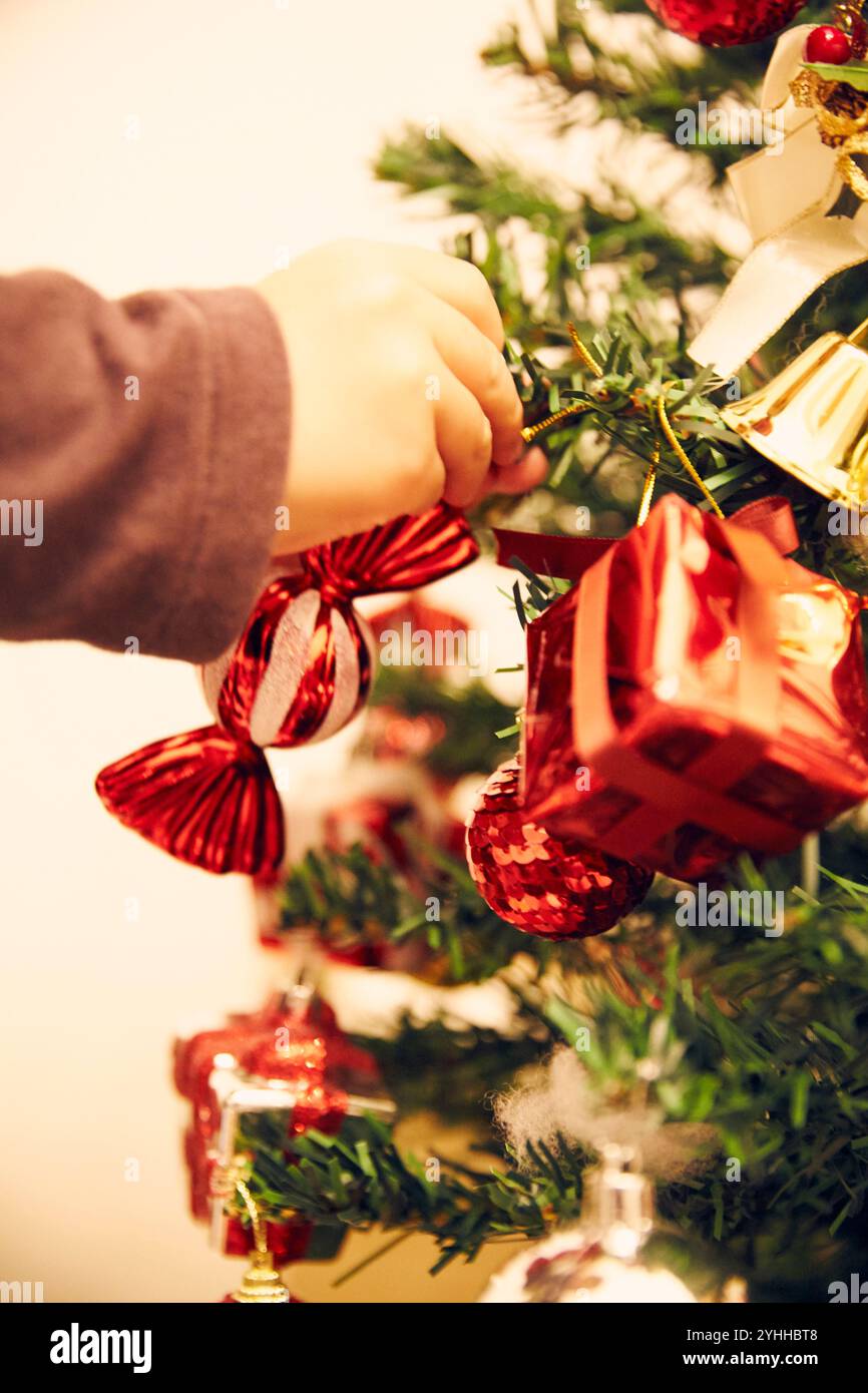 Boy decorating Christmas tree Stock Photo