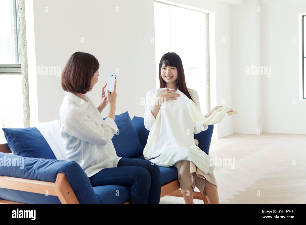 Two women in their 20s taking photos Stock Photo - Alamy