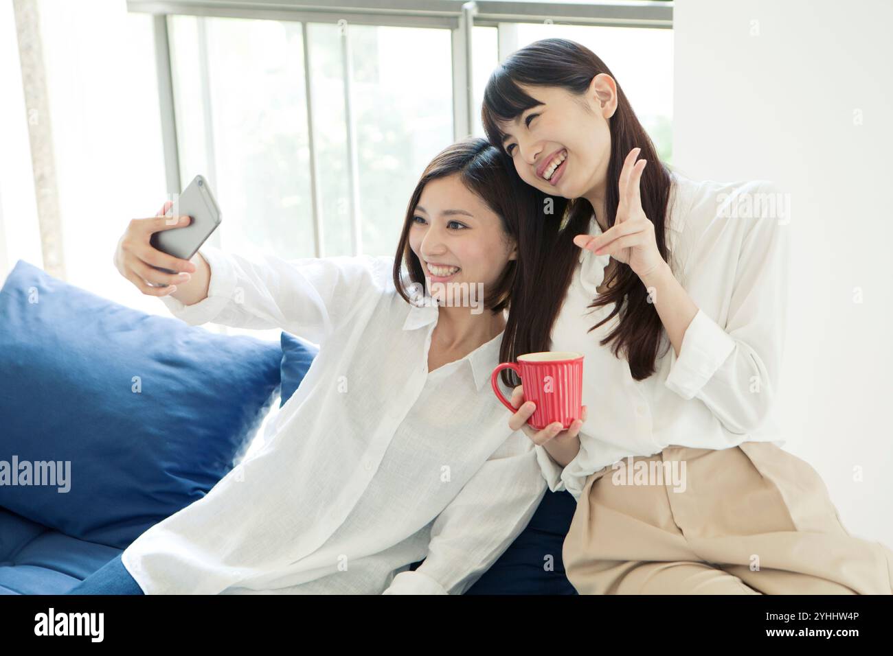 Two women in their 20s taking a selfie Stock Photo - Alamy