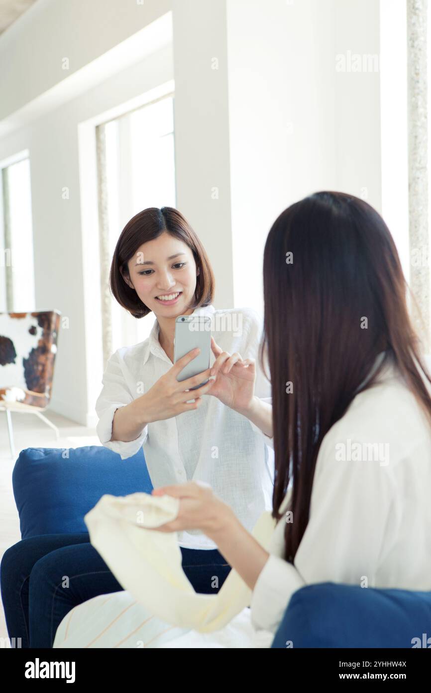 Two women in their 20s taking photos Stock Photo - Alamy