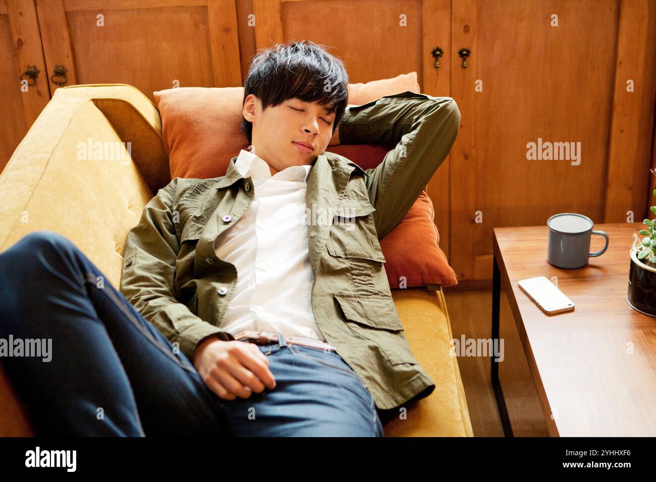 Young man sleeping in sofa hi-res stock photography and images - Alamy