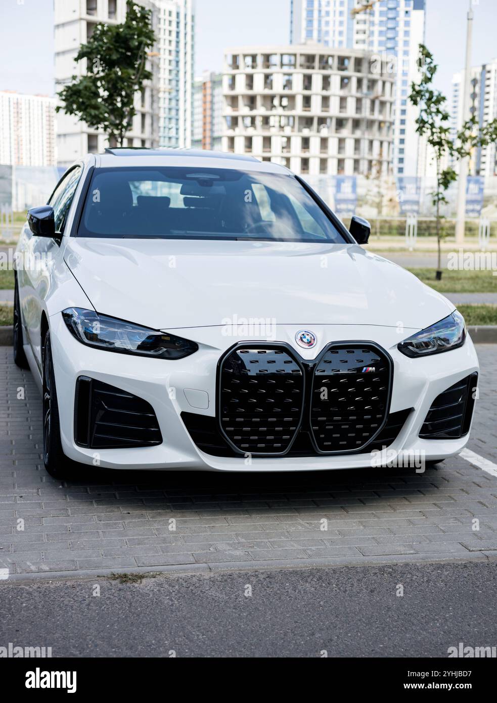 Minsk, Belarus, November 12, 2024 - Luxury BMW i4 M50 sedan, front body exterior. View on headlights and front grille of modern sports car. Stock Photo