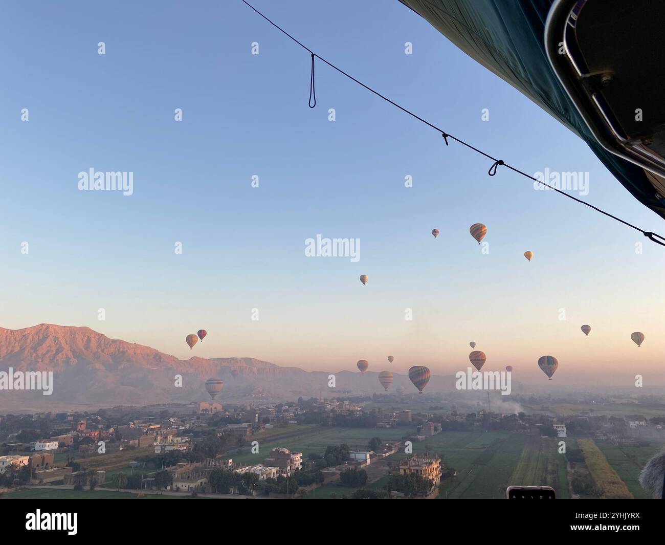 Hot air balloons flying in blue sky in Egypt with mountains in the ...