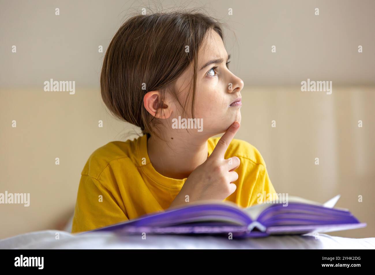 An interested and focused girl is reading a book. Emotion concept Stock ...