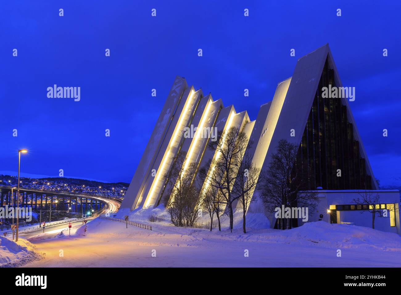 Illuminated Ishavskatedralen or Ice Sea Cathedral in winter, behind Tromso Bridge, twilight, Tromso, Troms, Norway, Europe Stock Photo