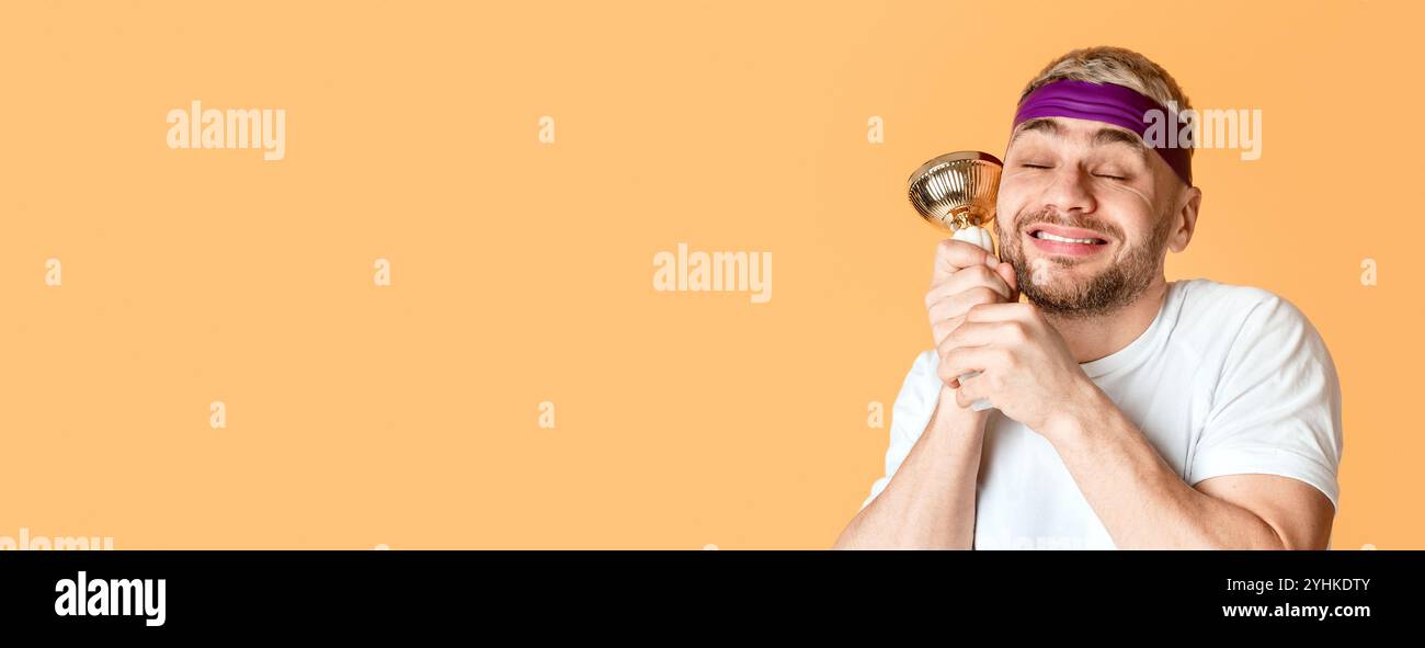 Happy millennial man holds reward and close his eyes Stock Photo - Alamy