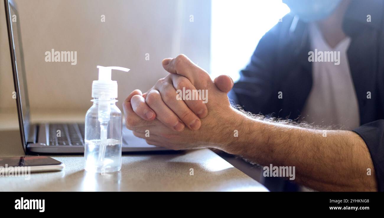 Unrecognizable Man Using Sanitizer Disinfecting Hands Before Work, Panorama, Cropped Stock Photo