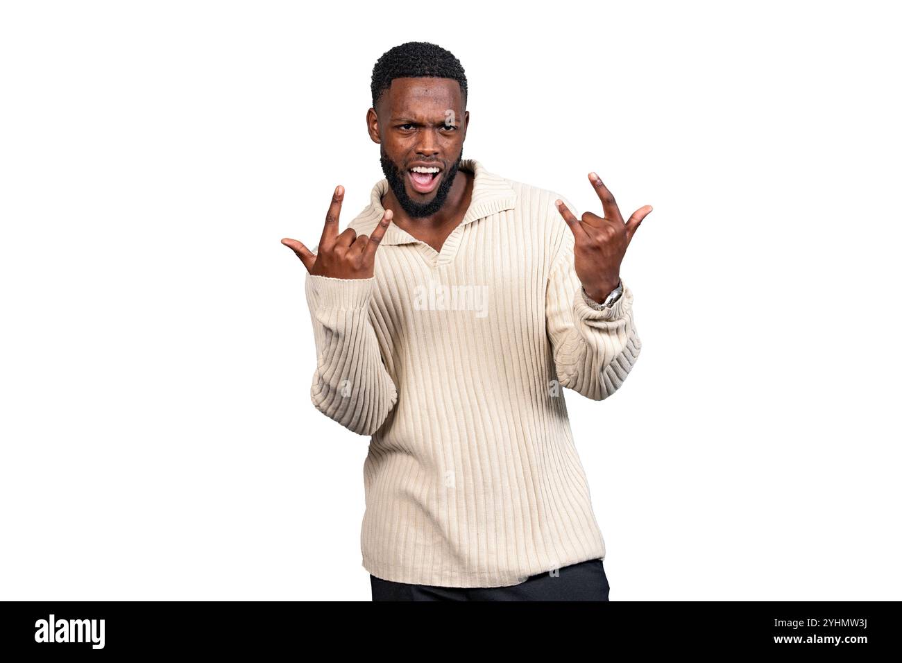 Cheerful young man making rock and roll gesture with hands, enjoying music and feeling energized Stock Photo